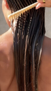 Como lavar o cabelo corretamente mulher penteando o cabelo.